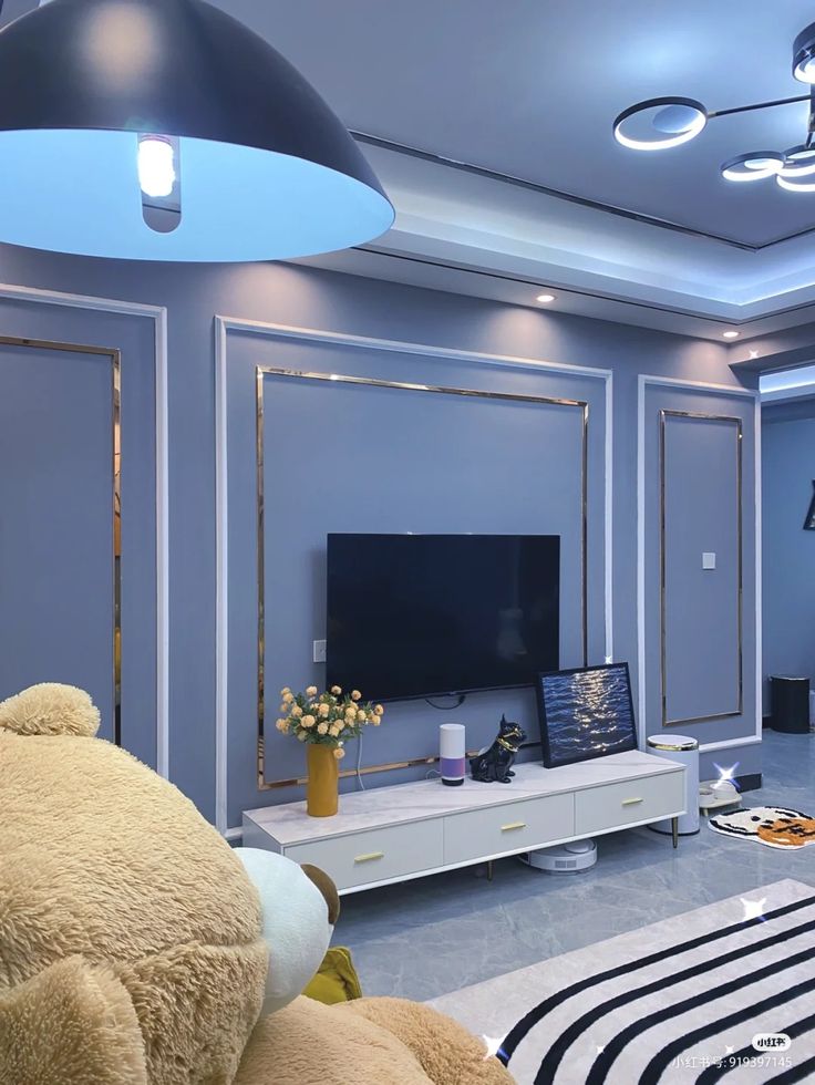 there is a large teddy bear sitting in front of the television on the dressers