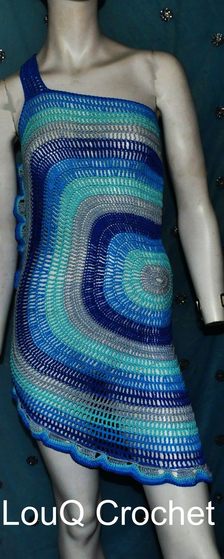 This hand crocheted dress is made from 100 % cotton in a circle design of varying blues. It has a strap over one shoulder and a ruffle down one side and around the bottom. This dress has some give in it making it variable for sizing from AU 8 to 12 possible a small 14. Blue Sleeveless Bohemian Crochet Dress, Blue Crochet Sleeveless Dress, Bohemian Blue One-shoulder Dress, Blue Crochet Dress, Handmade Blue Dresses For Spring, Handmade Blue Summer Dress, One Strap Dresses, Strap Dress, Circle Design