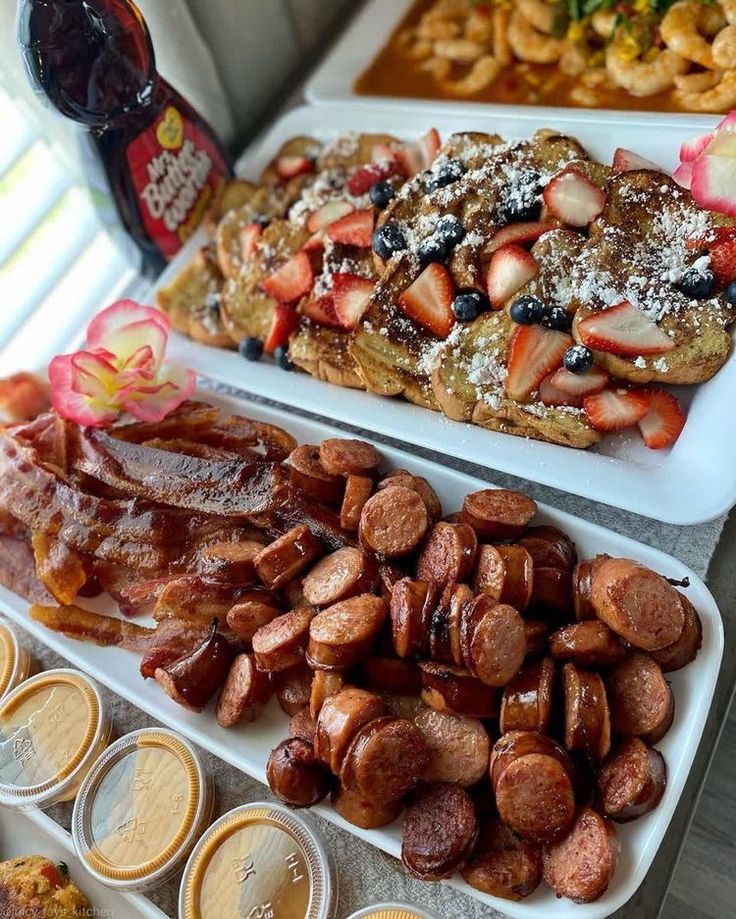 two trays filled with different types of food on top of a table next to each other