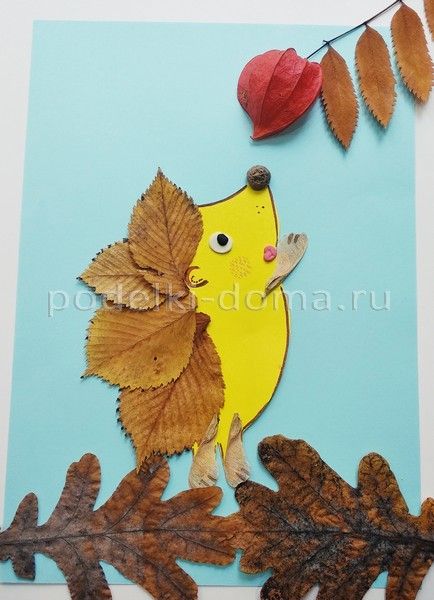 a paper cut out of leaves with a bird on it's head and an acorn