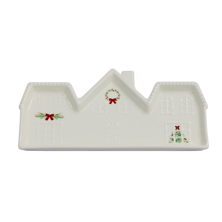 a white christmas house shaped dish with holly wreaths on the front and red bows