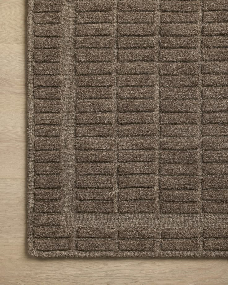 a brown rug on top of a wooden floor