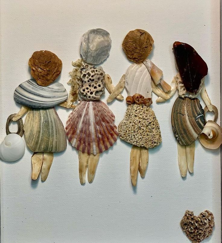 an image of four dolls made out of seashells