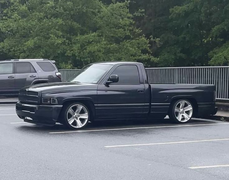 a black pickup truck parked in a parking lot