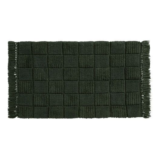 a green rug with fringes on it