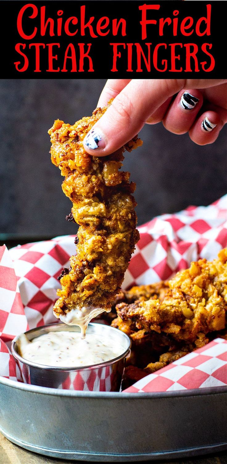 chicken fried steak fingers being dipped with ranch dressing