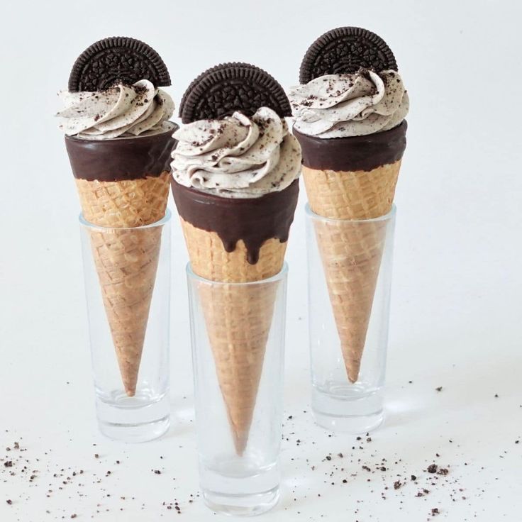 three ice cream cones with oreo cookies in them