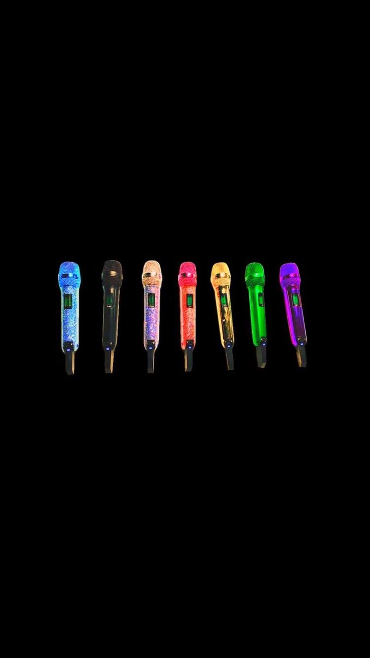 six different colored pens lined up in a row on a black background with the same color