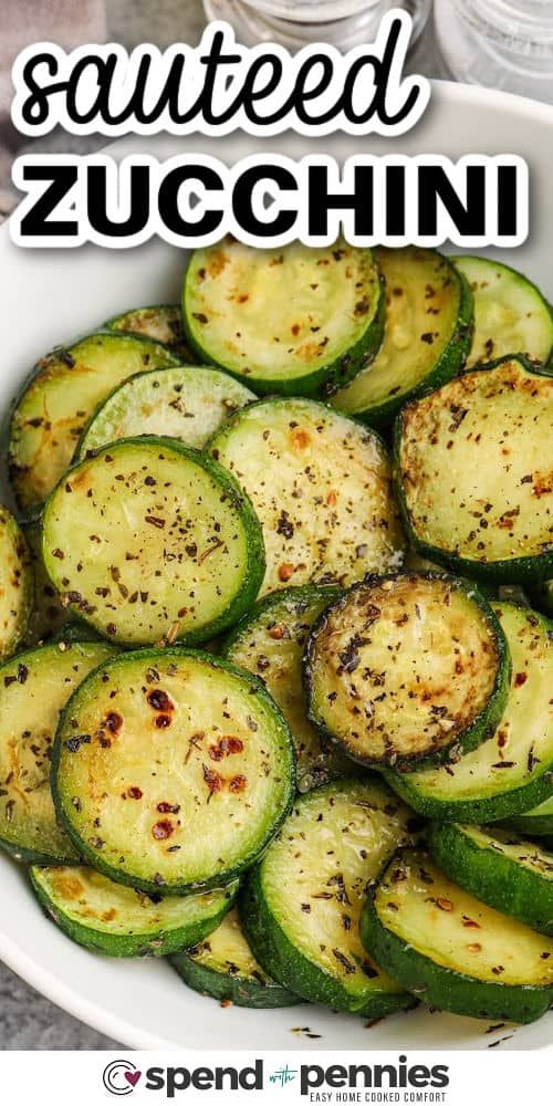 a white bowl filled with sliced zucchini on top of a table