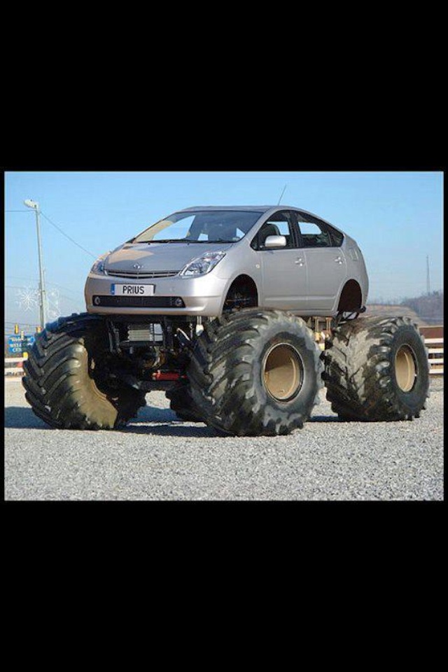 a silver car with four large tires on it