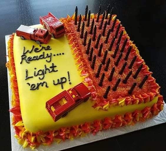 a birthday cake that is shaped like a firetruck with the words, we're ready to light up