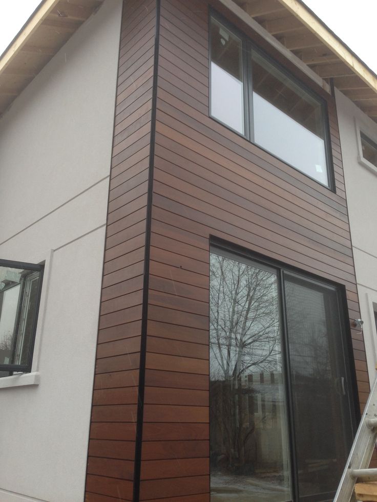 a house that has some windows on the side of it and is made out of wood