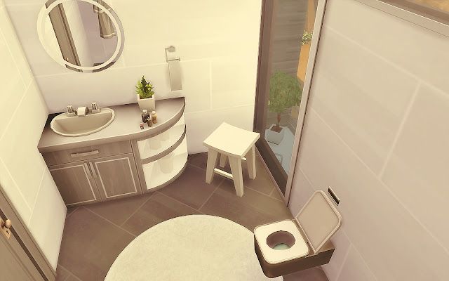 a bathroom with a toilet, sink and mirror in it's corner area next to a shower stall