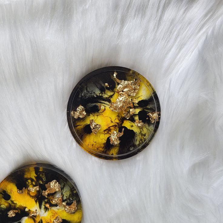 two yellow and black plates sitting on top of white fur