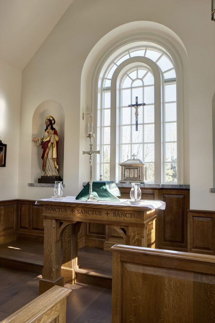 an empty church with wooden pews and stained glass windows