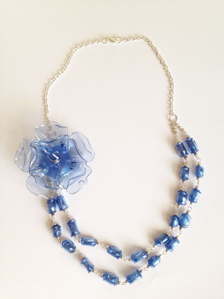 a necklace with blue beads and a flower on it