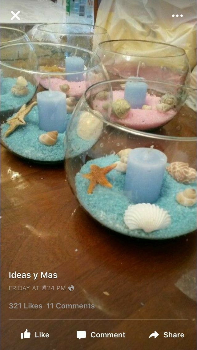 three glass bowls filled with candles on top of a wooden table