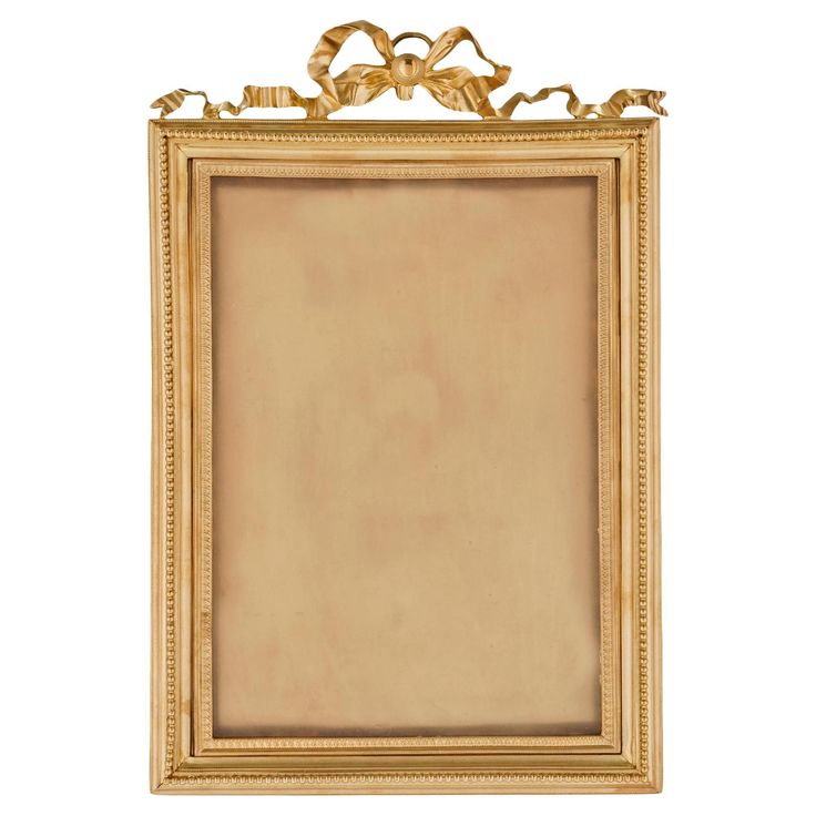 an antique gold frame with ornate decoration