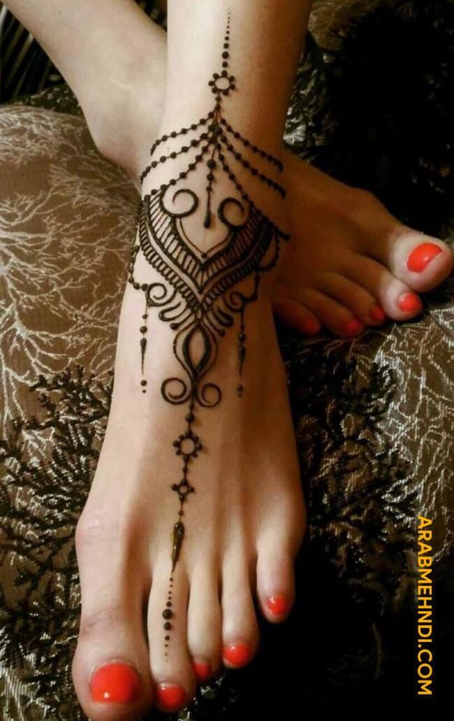 a woman's foot with a henna tattoo on it