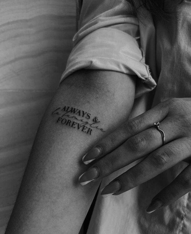 a woman's arm with the words always and forever tattooed on it