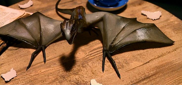 two fake bats sitting on top of a wooden table