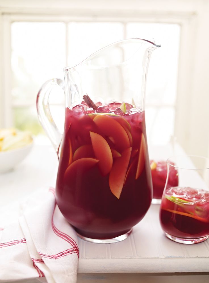 a pitcher filled with liquid sitting on top of a table