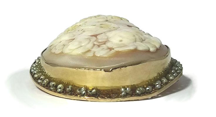 Item: Brooch/Pendant Circa: 1837 - 1901, probably The Romantic Period (1837-1860) Cameo Material: Carnelian Shell Decorative Material: Natural Seed Pearls on border of tiny filigree hearts. Metal: 14 kt Yellow Gold, Marked Size (Approximate): Oval Bezel 2.1875 inches long x 1.75 inch; Carnelian shell Cameo: 2.125 inches x 1.5 inches Weight: 21.93 grams Condition: Overall condition is excellent with no apparent damage. The bail, pin and clasp work properly. The tip of the pin which extends beyond Antique Carved Brooches For Weddings, Carved Yellow Gold Brooches For Wedding, Antique Carved Brooches For Formal Occasions, Elegant Carved Brooches For Gifts, Wedding Brooch With Cabochon Pendant, Wedding Pendant Brooches With Cabochon, Wedding Brooches With Cabochon Pendant, Unique Cabochon Brooches For Weddings, Unique Wedding Cabochon Brooches