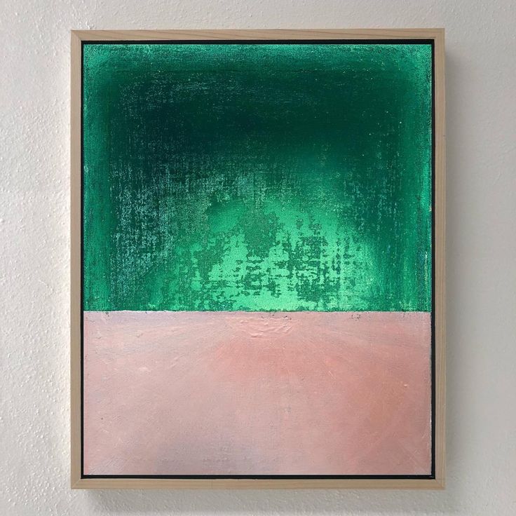 an abstract painting with green, pink and white colors on a wall in a frame