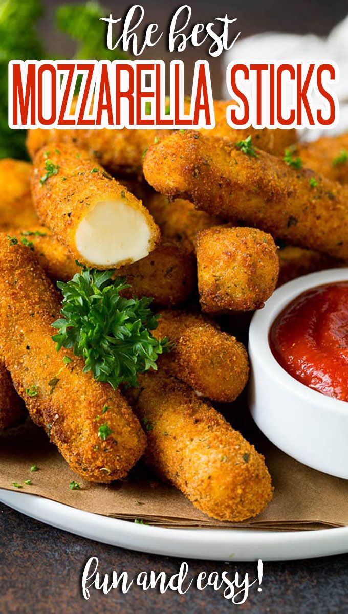 some fried food is on a plate with ketchup and parsley next to it