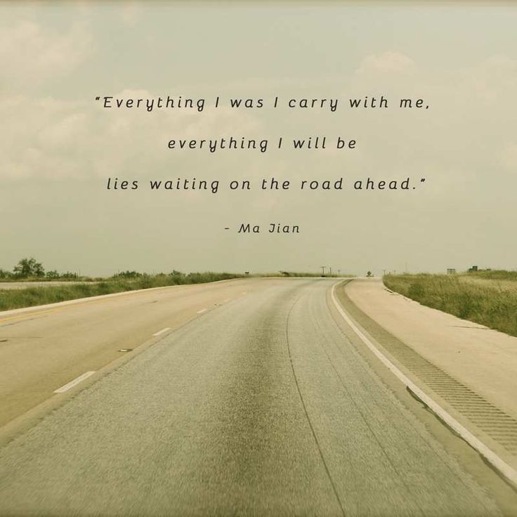 an empty road with a quote on it