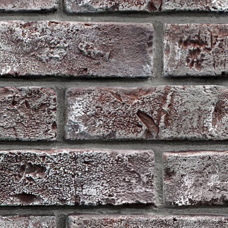 an old brick wall is shown with some snow on the bricks and it looks like they have been frosted