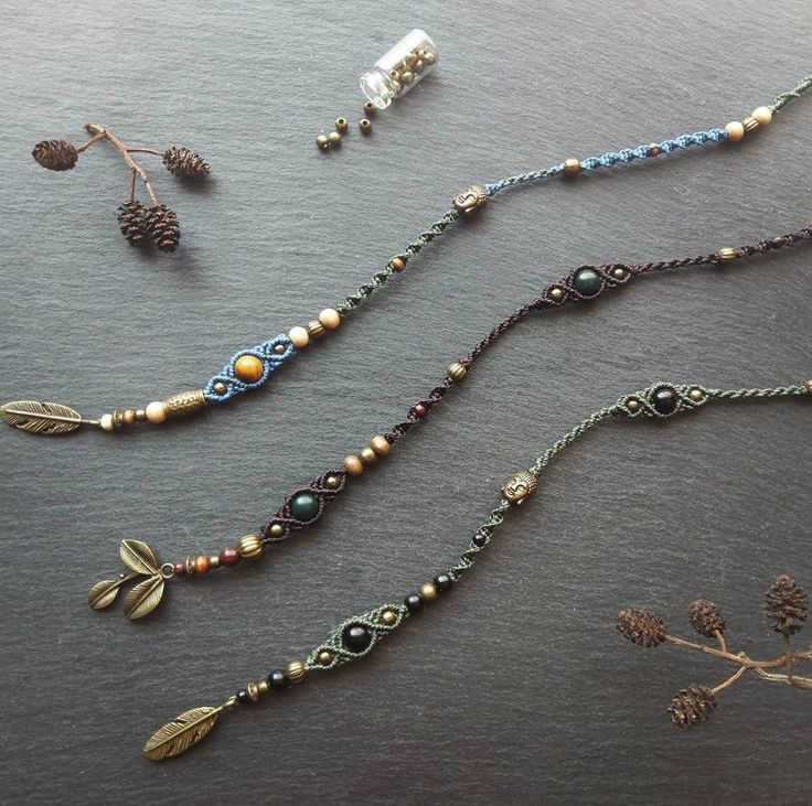 several beaded necklaces are laid out on a table