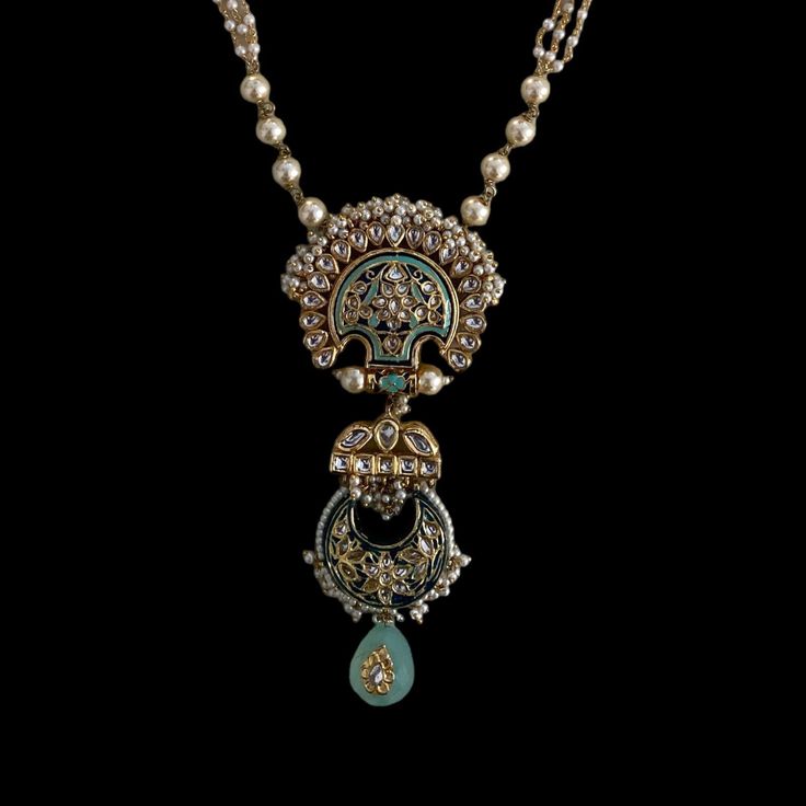 Experience the captivating contrast of blue meenakari work and an ornate barium drop in this stunning piece, bringing it to life with irresistible charm. Pair this necklace with your outfit for a classy and elegant look that is sure to turn heads. Finish: Gold Finish Material: Brass, Kundan, Barium, Pearls Color: Gold, White, Blue Size: One Size Closure Type: Box Lock Box Contains: 1 Necklace Elegant Locket Jewelry For Festivals, Elegant Festival Locket Jewelry, Traditional Long Locket Necklace, Festive Wedding Locket Jewelry, Temple Jewelry With Meenakari Round Pendant, Meenakari Temple Jewelry Round Pendant, Meenakari Round Pendant Temple Jewelry, Blue Fusion Style Tilla Jewelry, Blue Tilla Fusion Jewelry