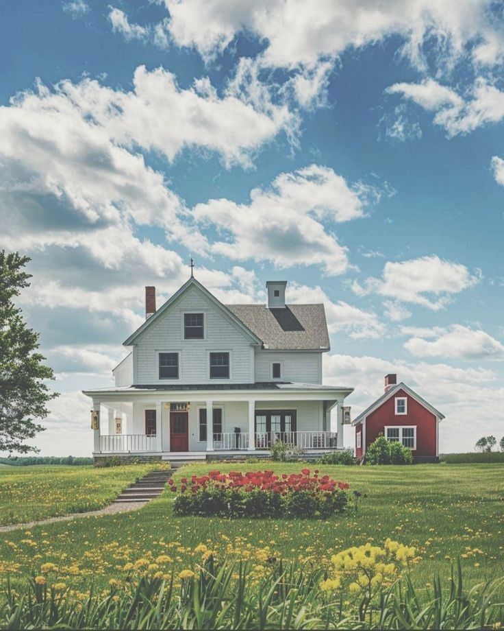 a large white house sitting on top of a lush green field