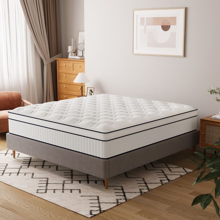 an image of a mattress in the middle of a living room with wood flooring