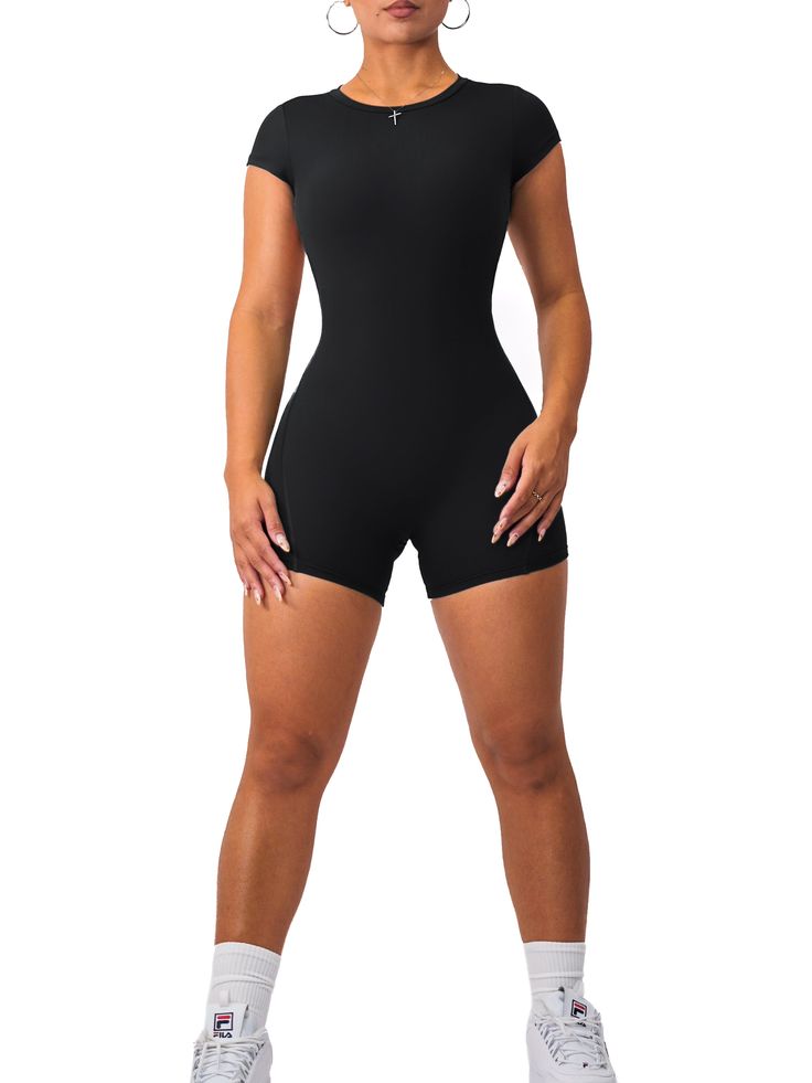 Description: NOW PADDED! This elegant romper is a must-have gym outfit! Its flattering design features an open back that will turn heads while keeping you secure and comfortable. All of our rompers & jumpsuits are made out of high quality blends of nylon and are guaranteed to shape your figure while providing high comfort and sweat resistance. Sizing: We recommend sizing up if you are 5'4 or taller. Color: Black Fabric: Active Fit Seamless Black Romper Outfit, Short Jumpsuit Outfit, Black Short Jumpsuit, Elegant Rompers, Fitted Romper, Black Playsuit, Short Romper, Romper Black, Jumpsuit Outfit