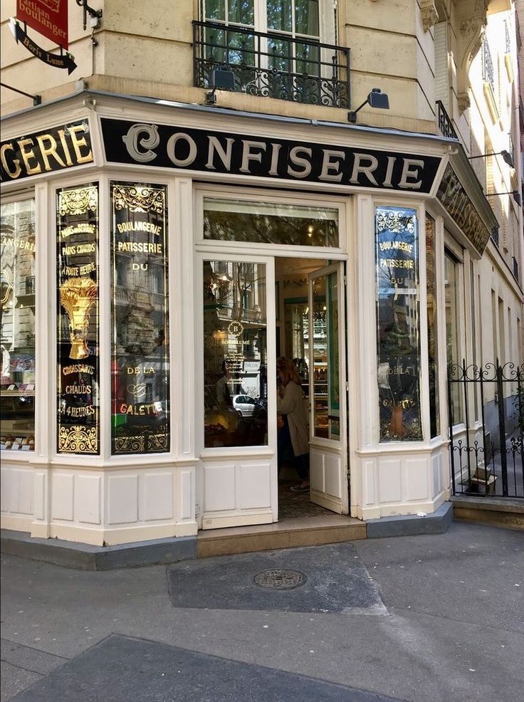 a store front with the door open on a street corner in paris's rue confisere