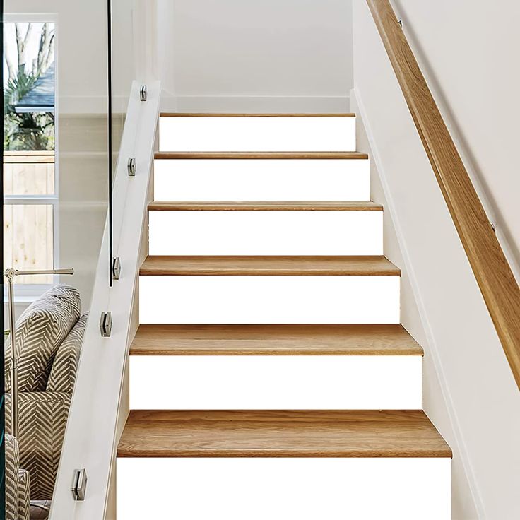 the stairs are made of wood and have glass railings