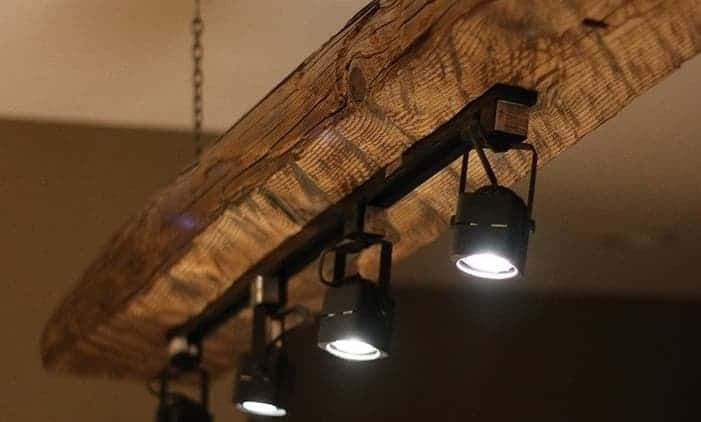 some lights are hanging from a wooden beam