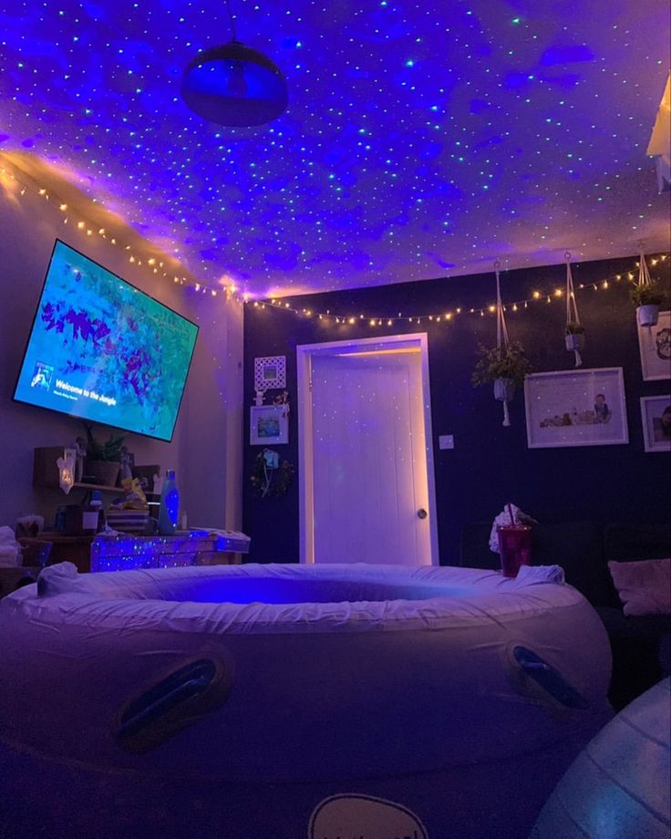 a room that has some lights on the ceiling and a large bed in front of it