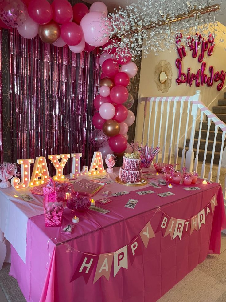 a birthday party with pink and gold decorations