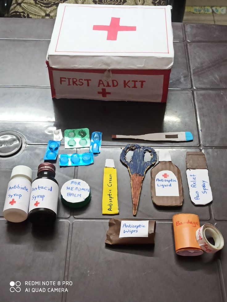 the first aid kit is laid out on the floor next to it's contents