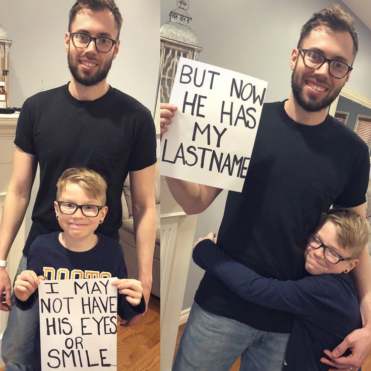 two men and a boy holding signs in front of their faces while standing next to each other