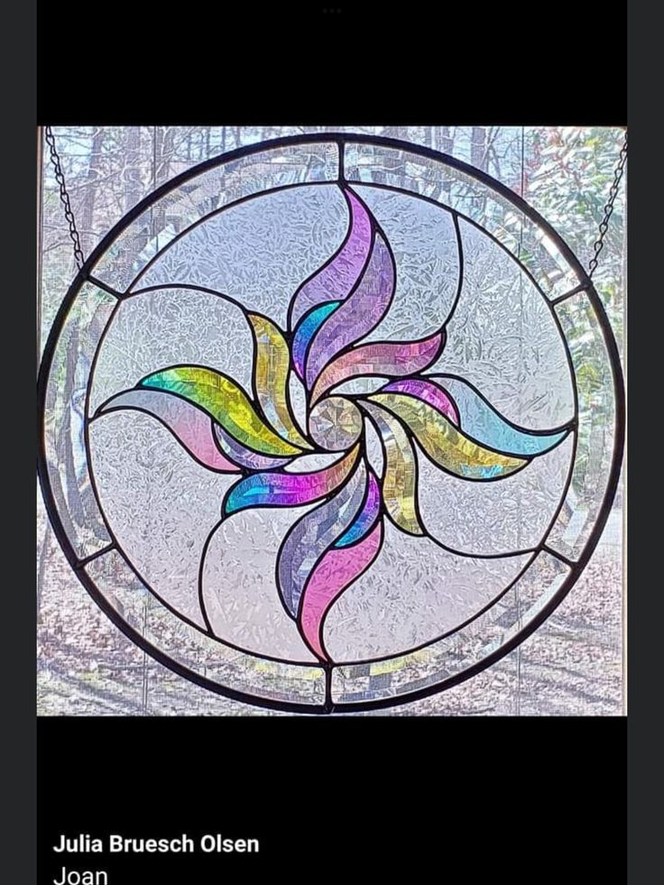 a stained glass window with an abstract design in the center and words julia brussch oleen on it