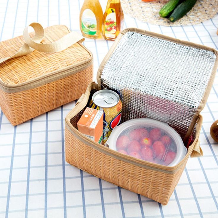 two wicker baskets filled with food on top of a table