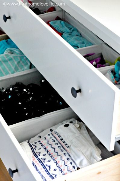 an open drawer with clothes in it