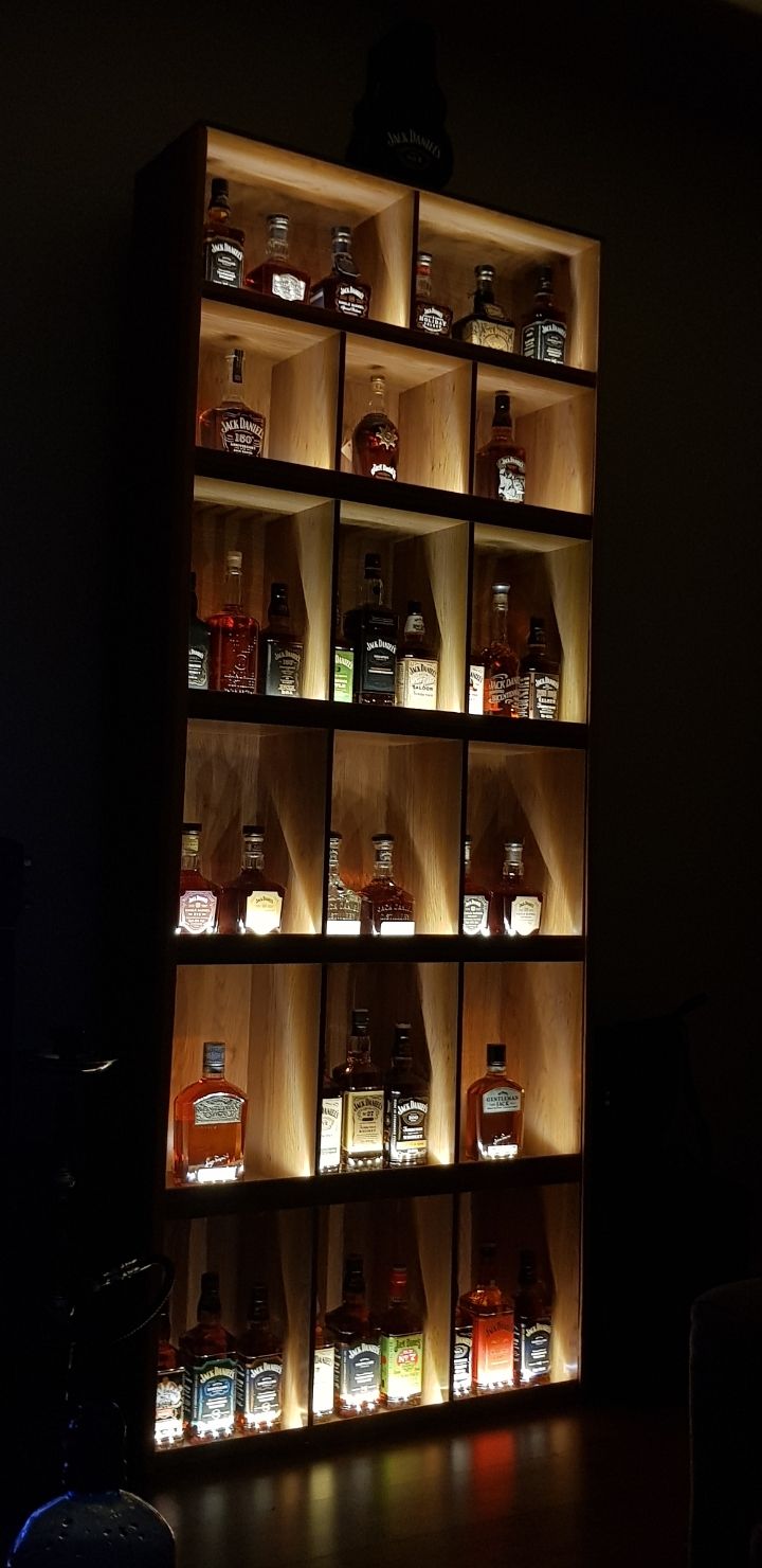 a shelf filled with lots of bottles on top of it