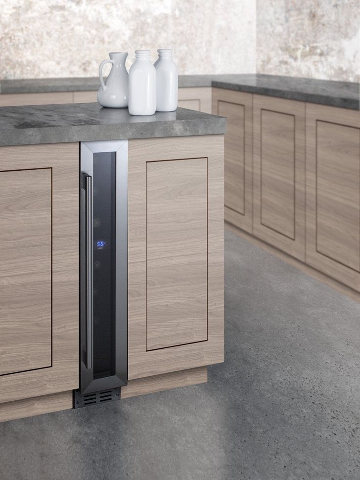 an image of a modern kitchen setting with vases on the counter and cabinets in the background