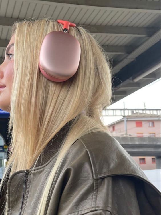 a blonde woman with headphones on her ears