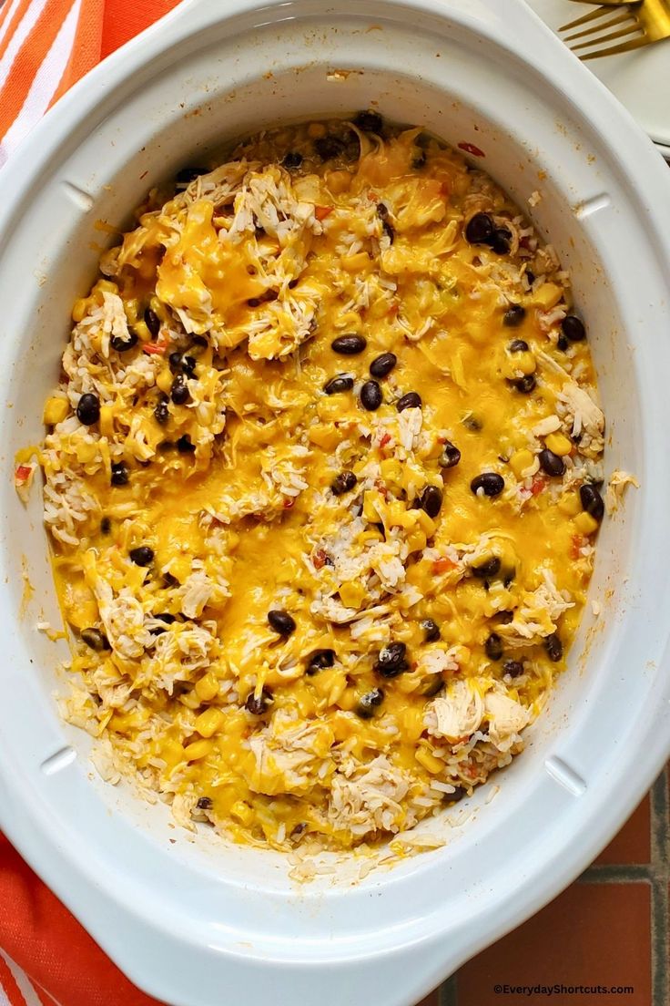 a casserole dish filled with chicken and black beans